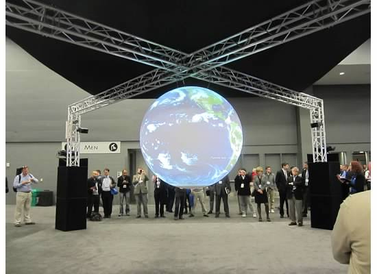 Attendees watch the weather of the world in the Exhibit Hall.