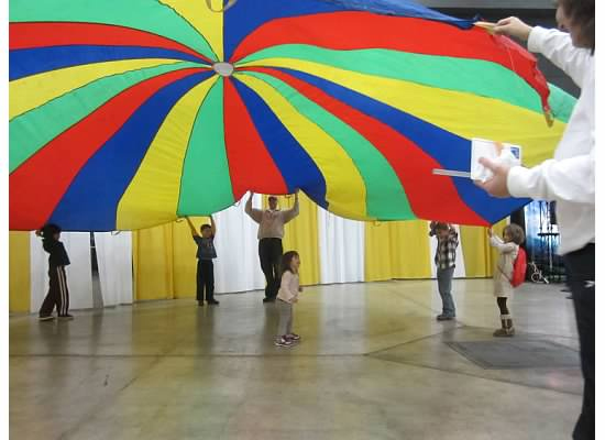 Children enjoy the popular parachute activity at WeatherFest.