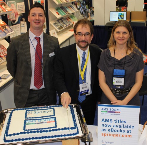 At the AMS Annual Meeting Springer Senior Publishing Editor Robert Doe with the knife-wielding AMS Publications Director Ken Heideman and AMS Books Managing Editor Sarah Jane Shangraw cut a deal--and a cake--that's best consumed on your favorite eReader.