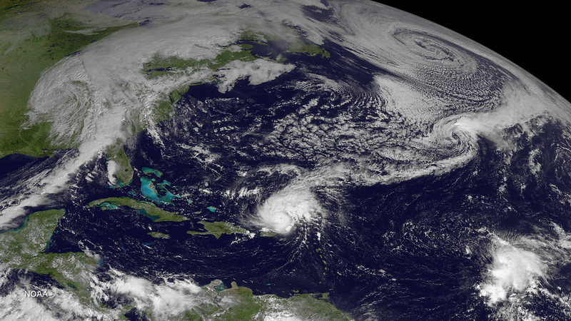 Satellite photo of Hurricane Gonzalo (a ball of swirling clouds) over the Atlantic near Puerto Rico; other larger cloud systems are seen in the upper part of the photo, eclipsed by the curvature of the Earth in the top right. Photo taken by GOES East satellite at 1445Z on October 14, 2014. Photo credit: NOAA.