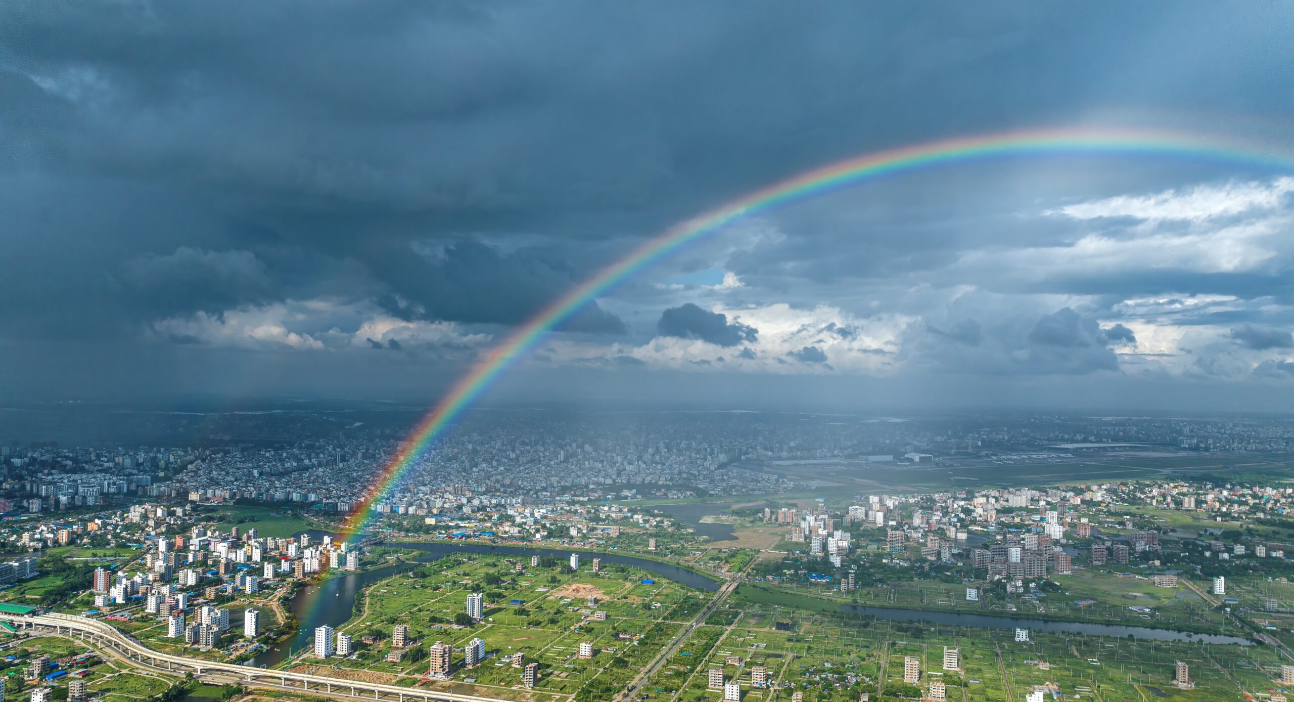 A rainbow over a city, shown from above