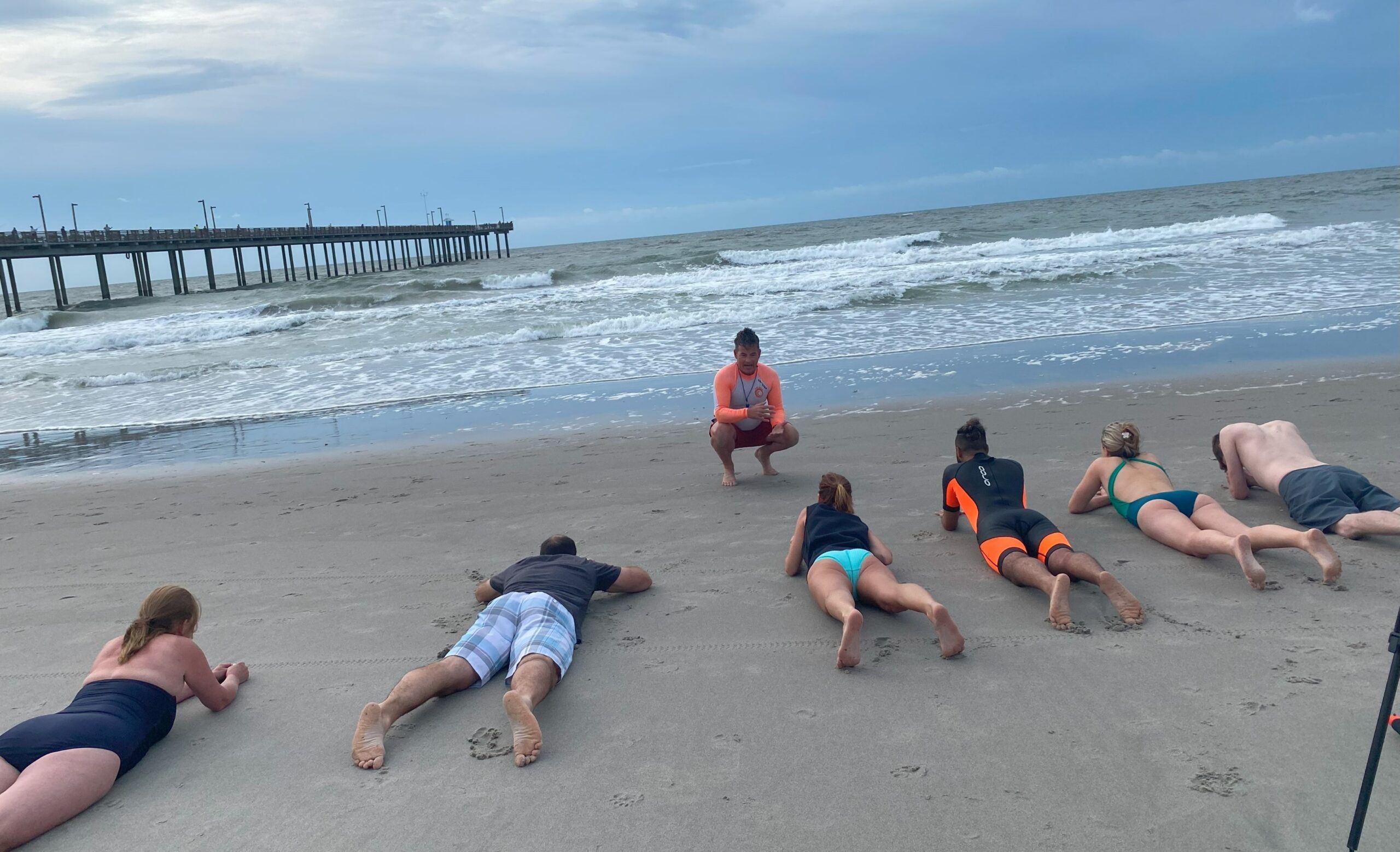 People lying down at the water's edge